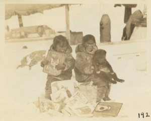 Image of Eskimo [Inuit] children looking over gift box